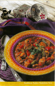 Southwest Turkey Tenderloin Stew in a colorful bowl with decorative elements on a wooden surface.