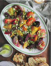 Load image into Gallery viewer, Colorful salad with tomatoes and greens on a white plate, served with bread and lime wedges.